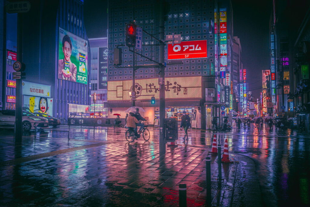 Tokyo street at night with neon lights reflected on wet pavement